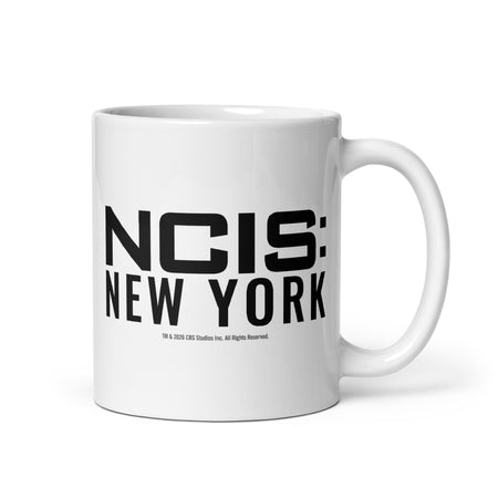 White ceramic coffee mug featuring the NCIS New York logo centered on the front