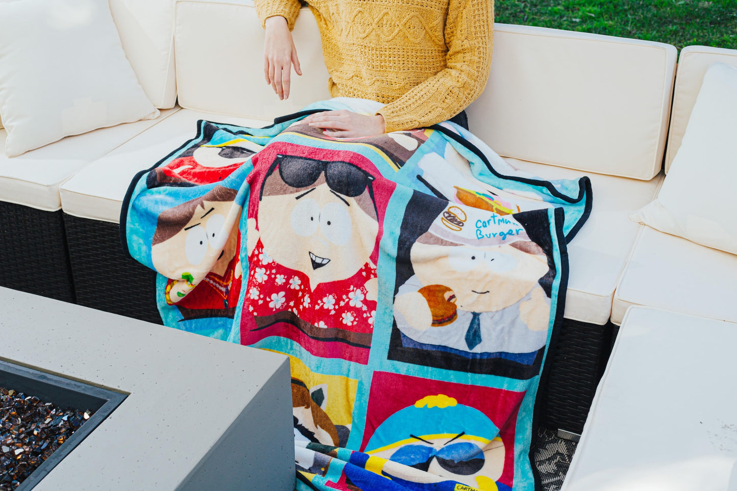 Full view of South Park throw blanket featuring Cartman's many-layered looks