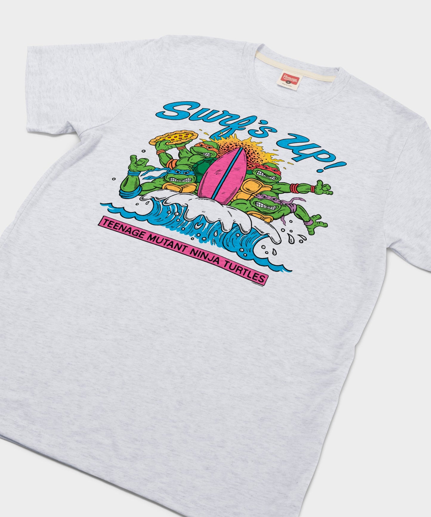 Close-up of the front graphic featuring TMNT characters surfing with a pizza slice