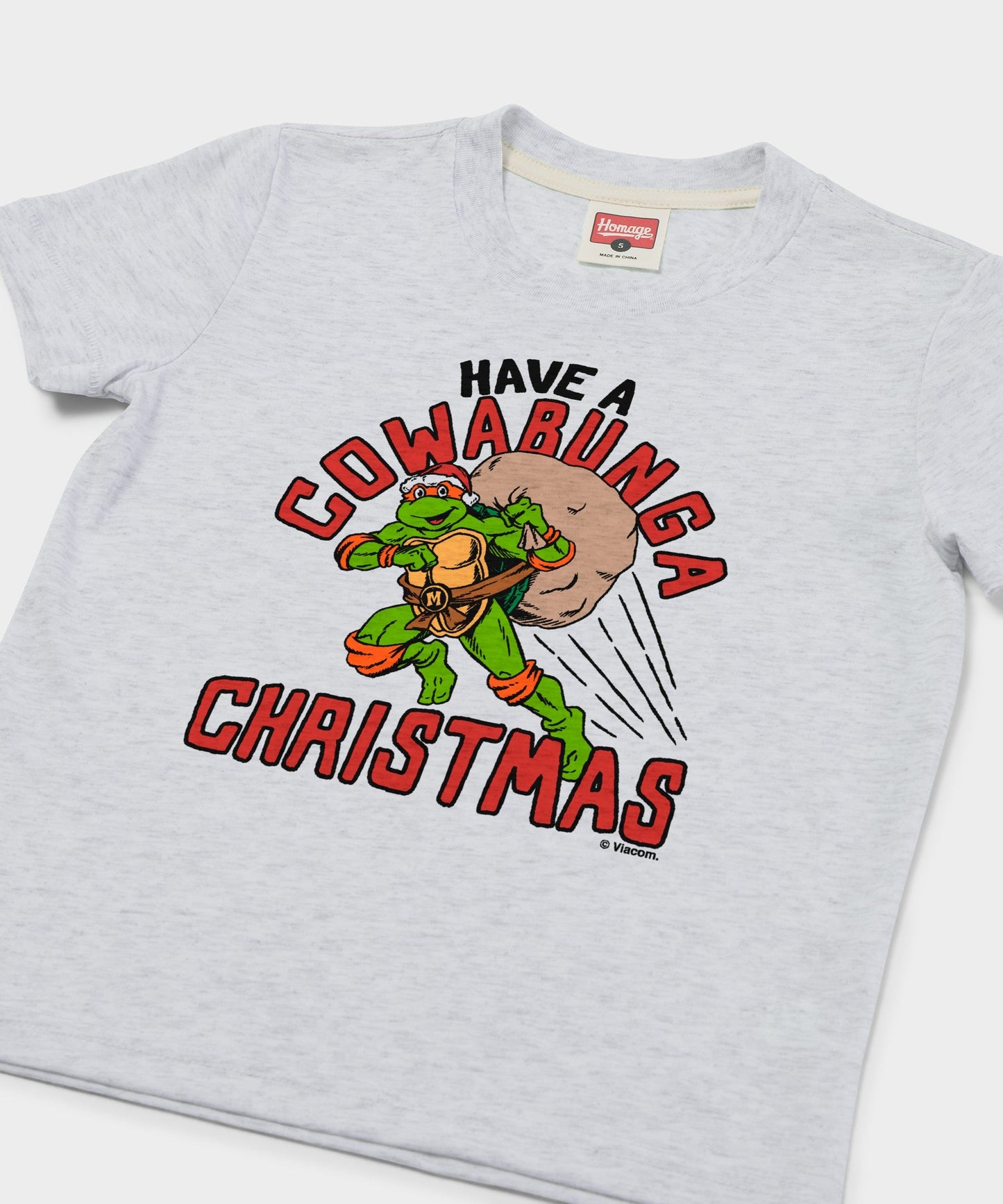 Close-up of the holiday TMNT graphic illustration on the front chest of the youth t-shirt