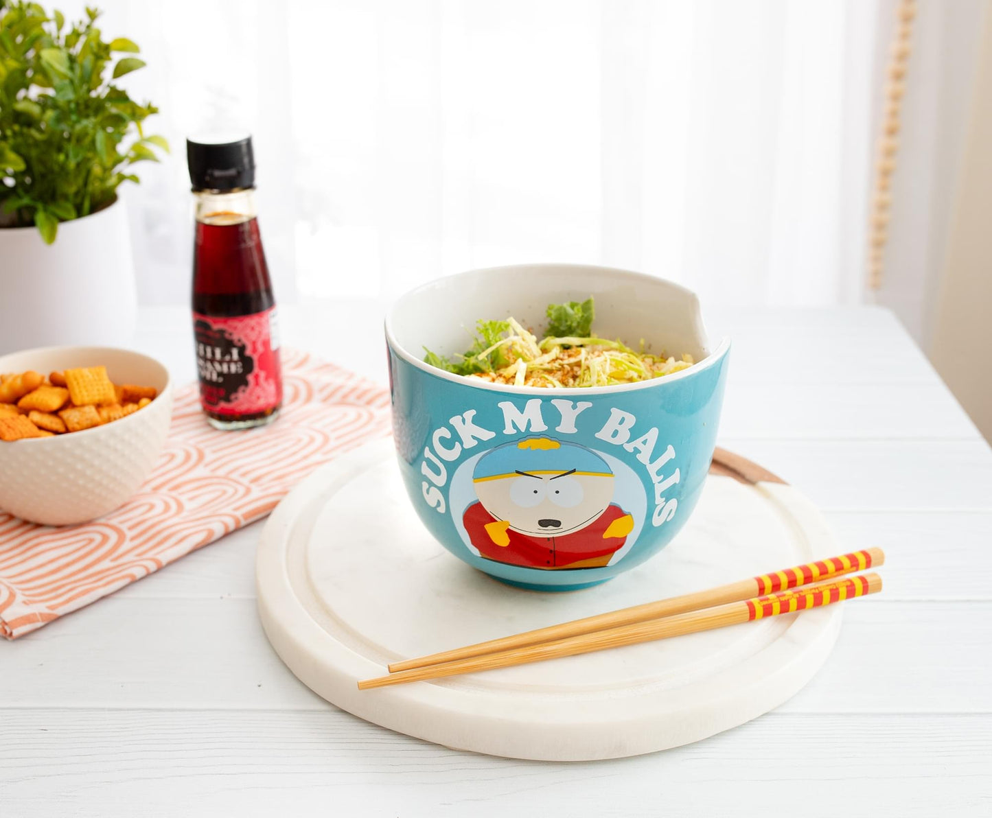 Included wooden chopsticks resting in the built-in notches of the ramen bowl
