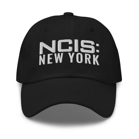 Front view of the NCIS: New York navy baseball cap featuring the embroidered logo centered on the crown
