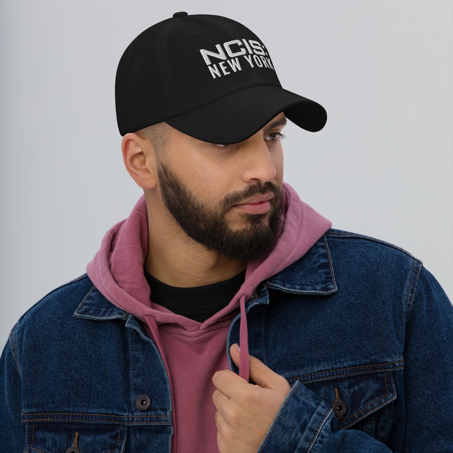 Back view of the NCIS: New York hat highlighting the adjustable strap with antique buckle