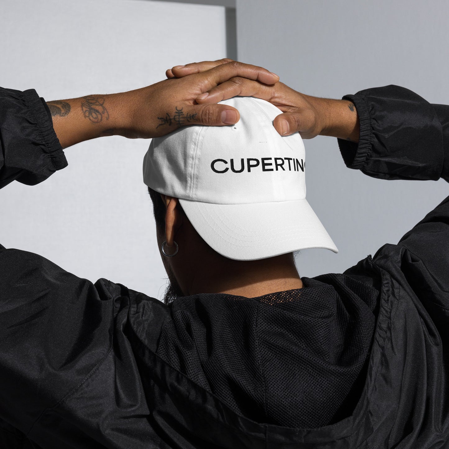 Angled profile view of the Cupertino hat resting on a flat surface