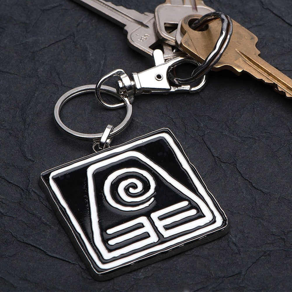 Officially licensed Avatar: The Last Airbender jewelry packaging with the Earth Kingdom keychain displayed.