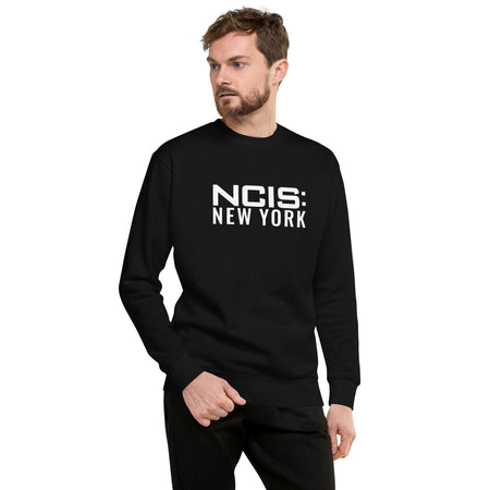 Close-up view of the NCIS: New York series logo printed on the chest of the cotton blend sweatshirt