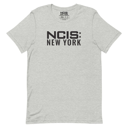 Close-up of the NCIS: New York text logo printed on the chest of the t-shirt