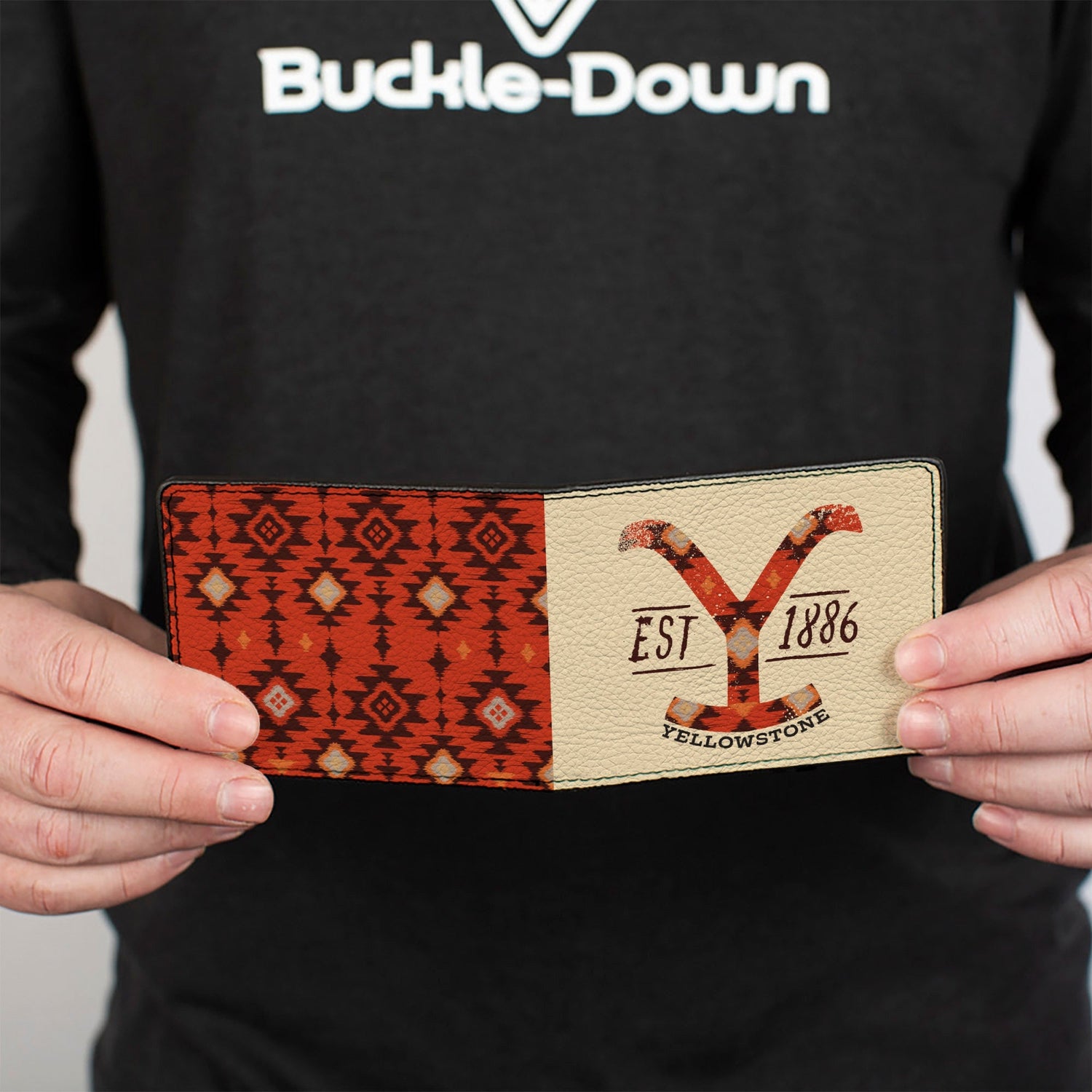 Close-up of the Dutton Ranch logo and stitching details on beige background
