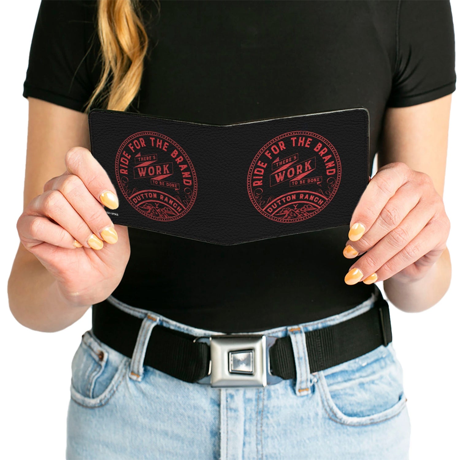 Wallet being held to show tactile vegan leather texture.