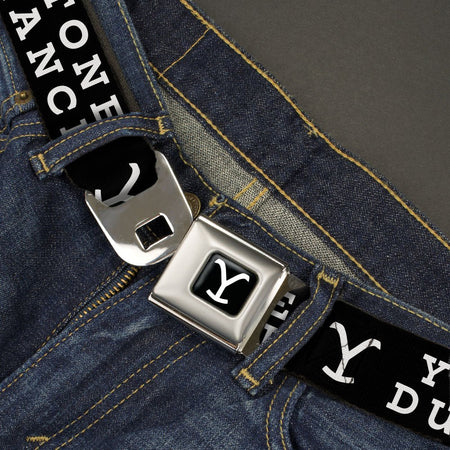 Close-up of the gold Y logo on the black seatbelt belt webbing
