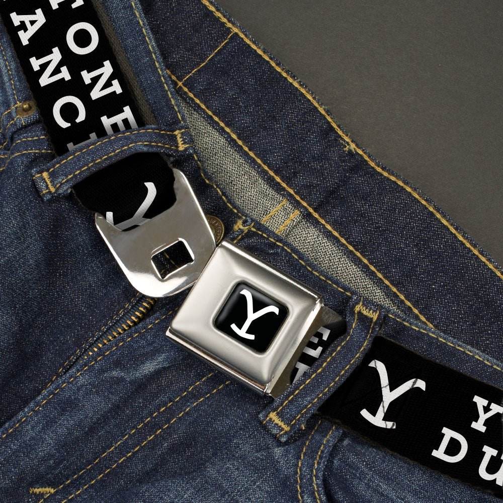 Close-up of the gold Y logo on the black seatbelt belt webbing